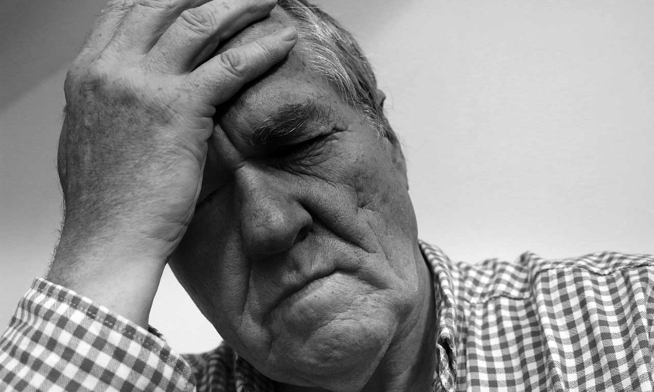 man holding head image